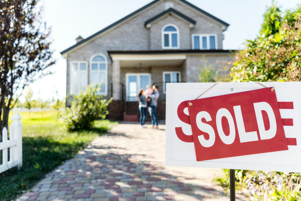 house with sold sign