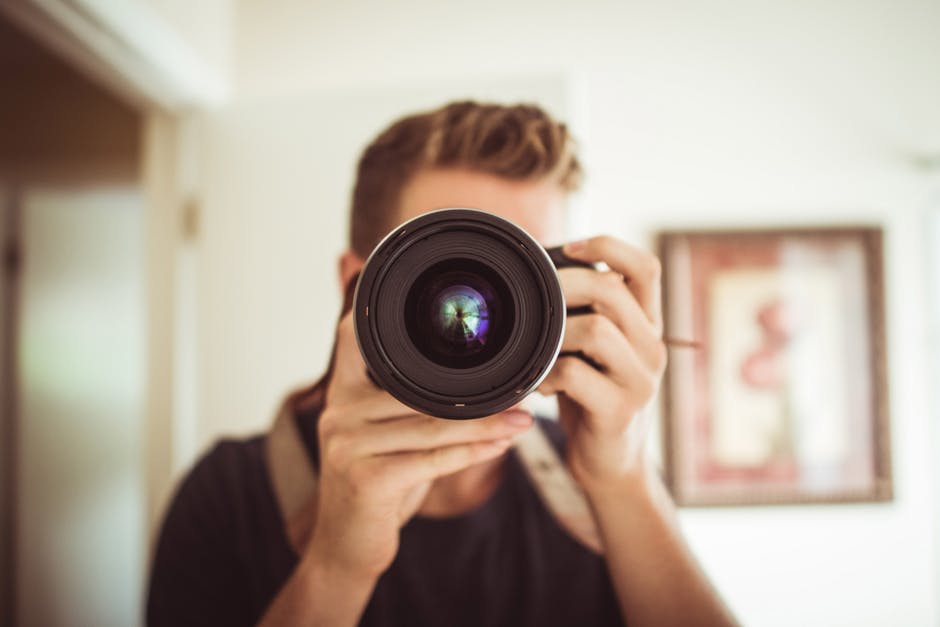 Man Taking Photographs of a House's Interior